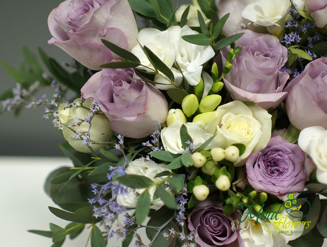 Bridal bouquet of purple roses, eustoma, and freesia photo